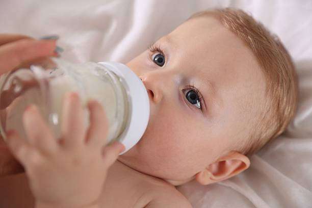 Cute little baby with bottle warmer