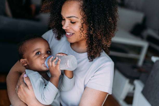 baby boy and enjoying motherhood at home. bottle warmer