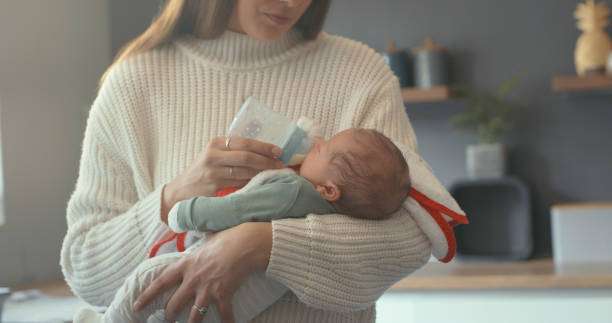 baby boy and enjoying motherhood at home. bottle warmer
