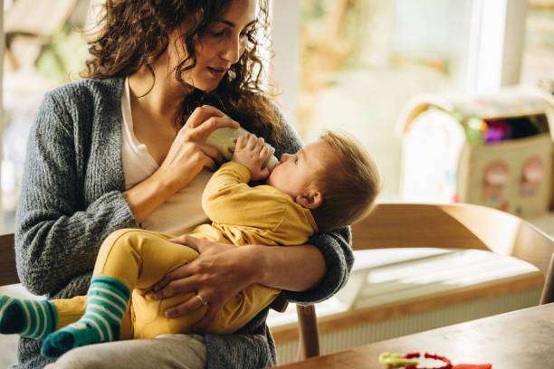 baby boy and enjoying motherhood at home. bottle warmer
