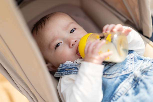 Cute little baby with bottle warmer