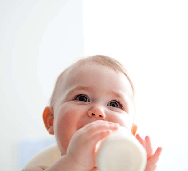 Baby girl drinking from bottle