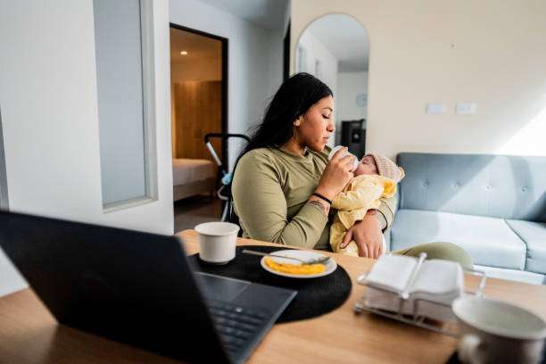 A bisexual mother giving her baby a bottle warmer at home