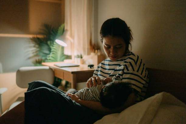 An Asian mother breastfeeding her baby at home. bottle warmer