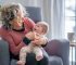 A beautiful grandma spending quality time with her 5-month-old granddaughter. bottle warmer